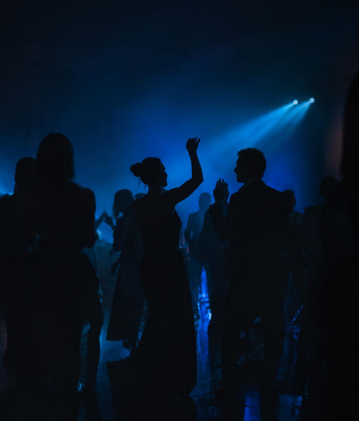 Guests celebrating on a dance floor at an evening event